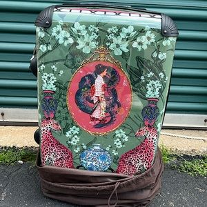 Two rolling/spinner hard-case carry-on sized bags, in blue and in green.